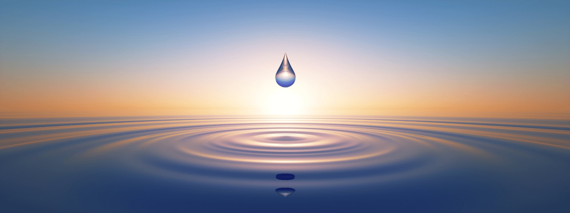 Water droplet in body water with sunset behind it