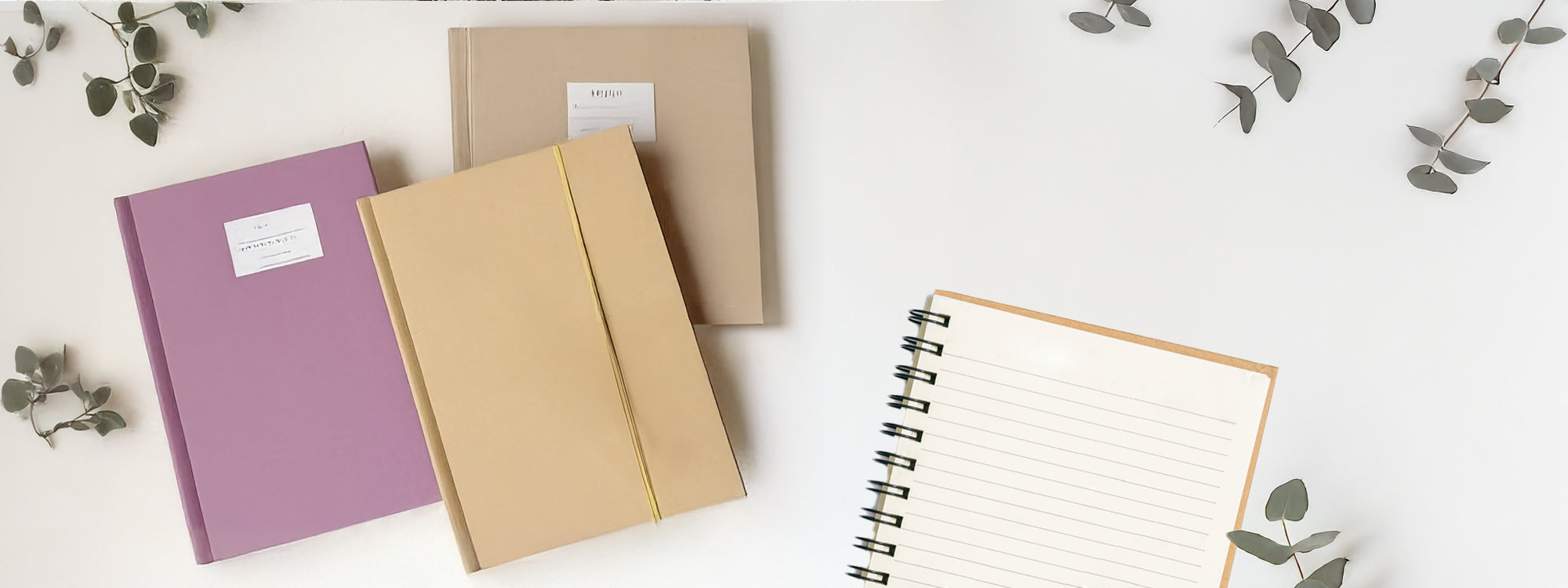 recycled paper spiral notebook with pencil and cup of coffee