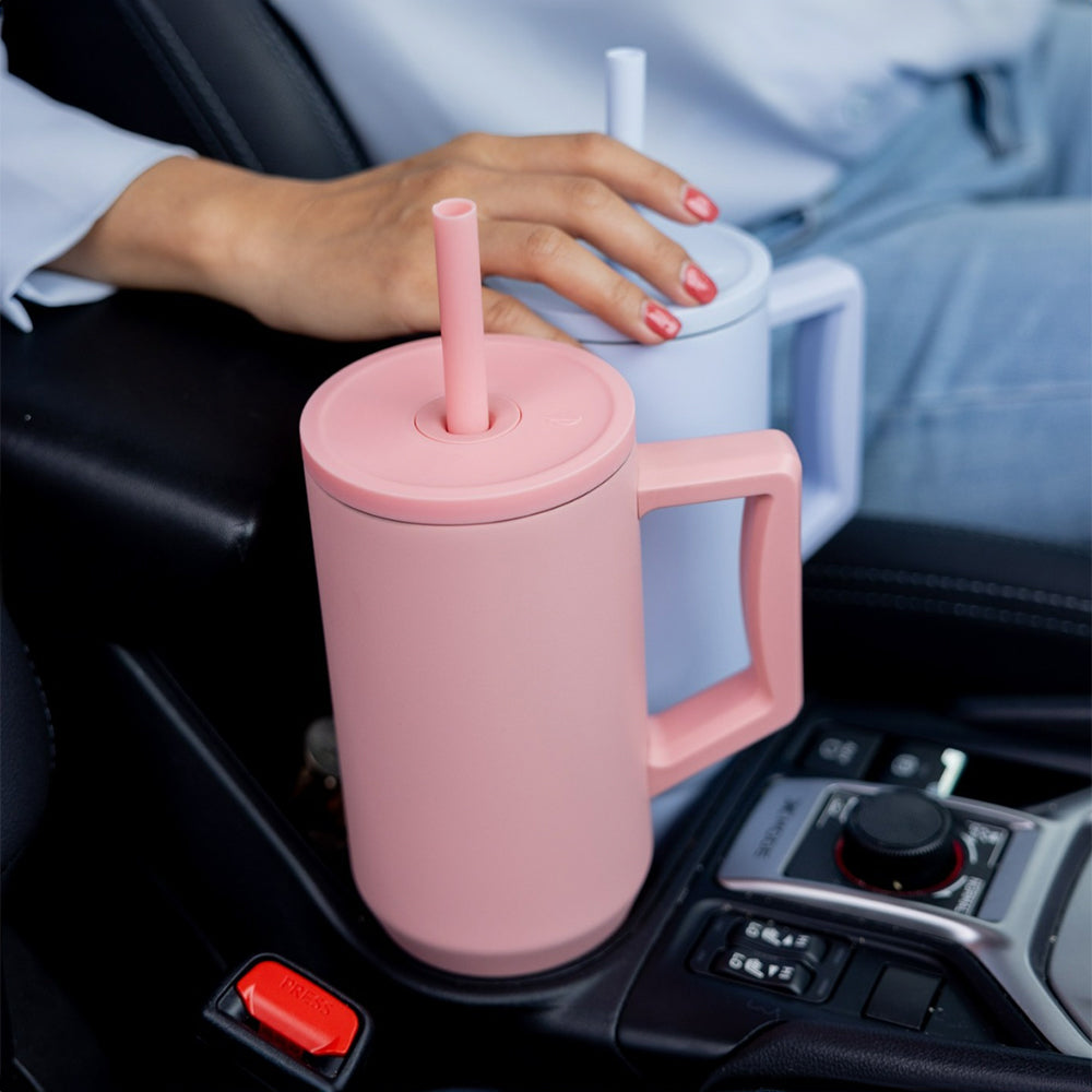 Customized Elemental 40 oz stainless steel tumbler with interchangeable straws in car cup holders.